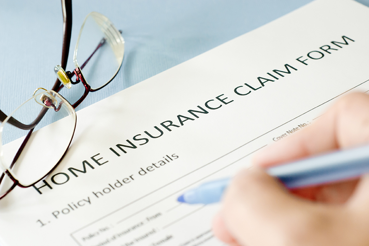 WHY CHOOSE US homeowners filling out insurance claim after a storm